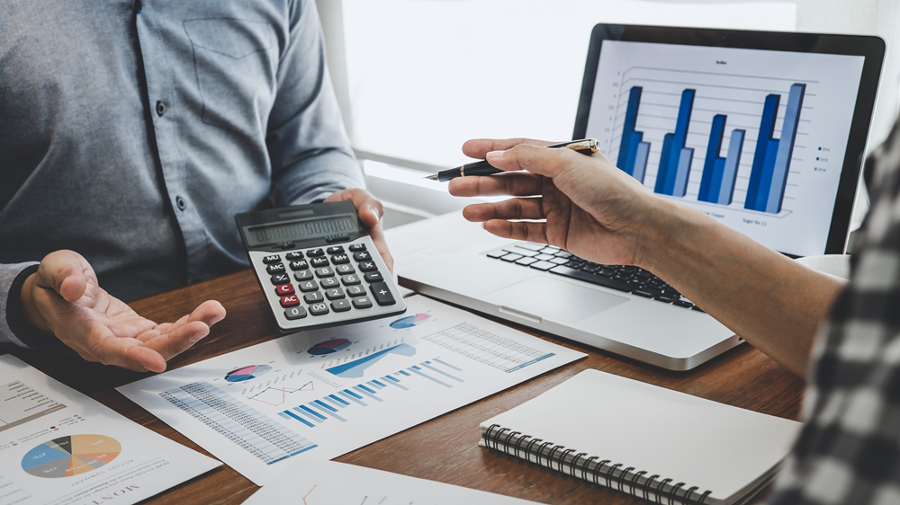 Business meeting analyzing financial charts and graphs