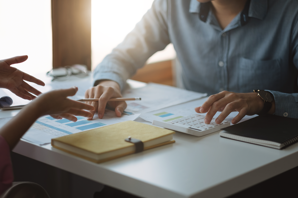 Business meeting with financial documents and calculator