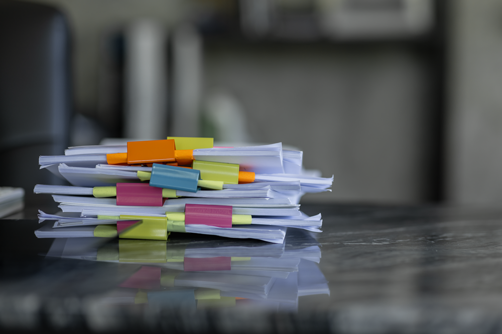 Organized stack of papers with colorful tabs